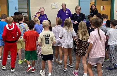Lions Steve Hall, Rob Ginder, Craig Cooley, and Dr. Kathleen Busby pass out dictionaries. (Photo provided by Westfield Lions Club)